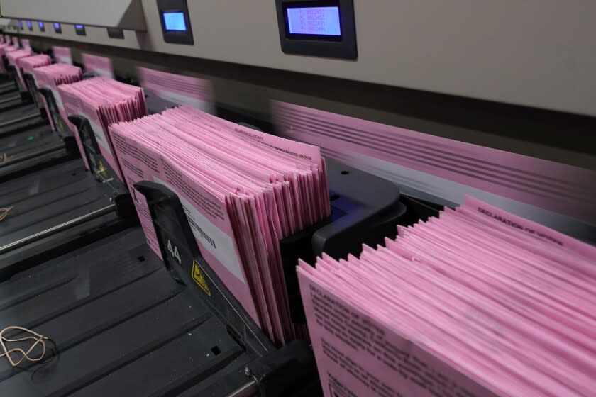 FILE - In this Aug. 30, 2021 file photo, mail in ballots run through a sorting machine at the Sacramento County Registrar of Voters office in Sacramento, Calif. A group of election security experts will ask California officials, Thursday, Sept. 2, to take additional steps to protect the upcoming governor's recall election after the unauthorized release of voting system software in other states. (AP Photo/Rich Pedroncelli, File)