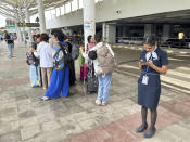 Passengers wait outside the Indira Gandhi International Airport in New Delhi, India, Friday, June 28, 2024. A portion of the canopy at a departure terminal of the airport collapsed early Friday as heavy pre-monsoon rains lashed the Indian capital. (AP Photo/Shonal Ganguly)