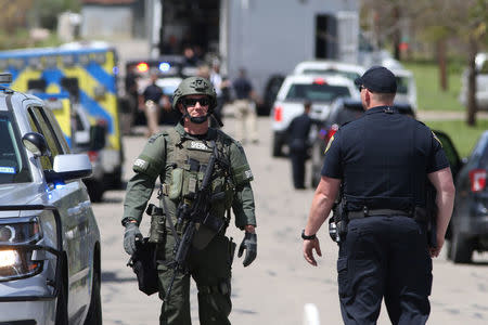 Law enforcement personnel investigate a neighborhood containing the home where the bomber was suspected to have lived in Pflugerville, Texas, U.S., March 21, 2018. REUTERS/Loren Elliott