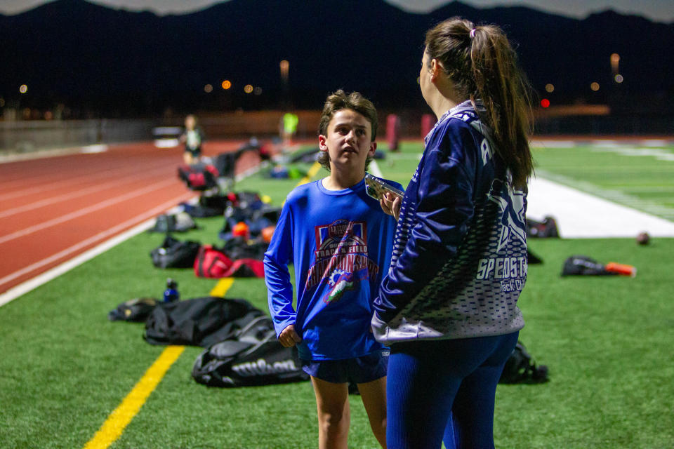 Devin LeVander talks with his mother, Darah, during practice at ALA West Foothills High School in Waddell, Ariz., on Feb. 13, 2024.
