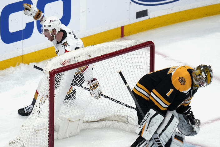 Vegas Golden Knights right wing Reilly Smith, left, celebrates after scoring on Boston Bruins goaltender Jeremy Swayman (1) during a shoot out following an overtime period, during an NHL hockey game, Monday, Dec. 5, 2022, in Boston. Smith scored the only goal in the shoot out, helping the Knights defeat the Bruins 4-3. (AP Photo/Charles Krupa)