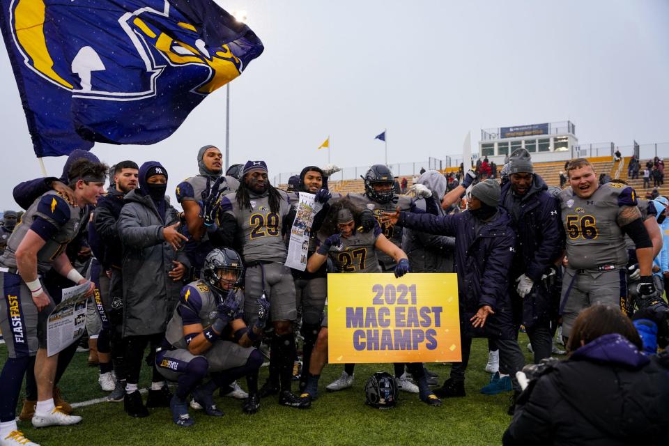 Kent State football players celebrate a MAC East Division victory over Miami in overtime at Dix Stadium on Saturday, November 27, 2021.