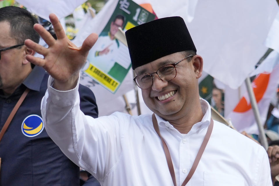 Presidential candidate Anies Baswedan greets supporters upon arrival to register to run in next year's election at the General Election Commission building in Jakarta, Indonesia, Thursday, Oct. 19, 2023. The world's third-largest democracy is set to vote in simultaneously legislative and presidential elections on Feb. 14, 2024. (AP Photo/Achmad Ibrahim)