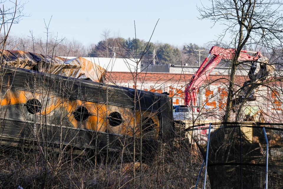 A derailed train car is seen from the backyard of home in East Palestine as crews continue cleanup on Feb. 14.