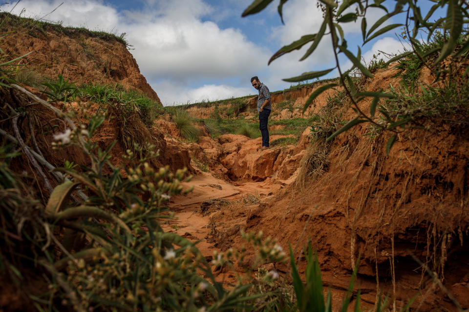 Victor Ziantoni agronomist, brother of Valter Ziantoni, observes a degraded and eroded area in Timburi.<span class="copyright">Victor Moriyama for TIME</span>