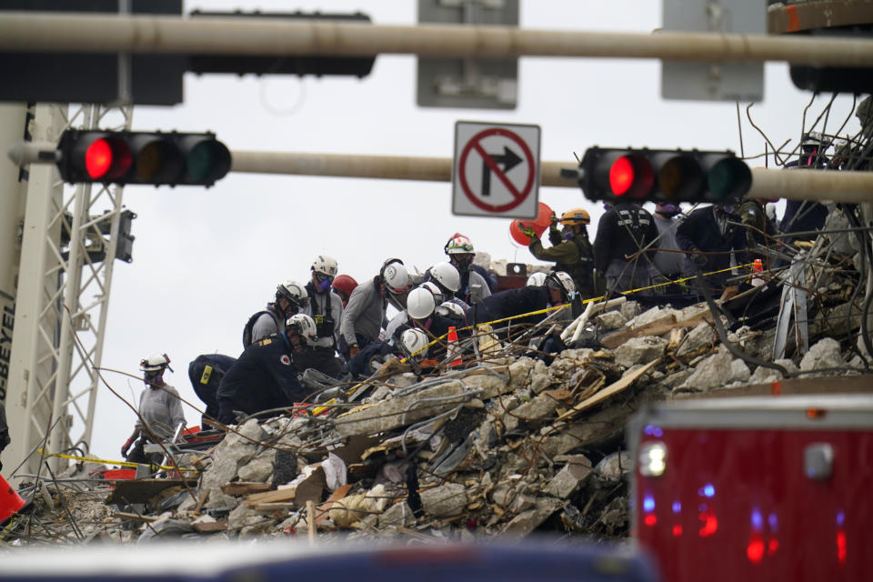 Search and rescue workers comb the rubble of an oceanfront condo building that collapsed, with many dead and unaccounted for, in Surfside, Fla., Tuesday, June 29, 2021. (AP Photo/Gerald Herbert)