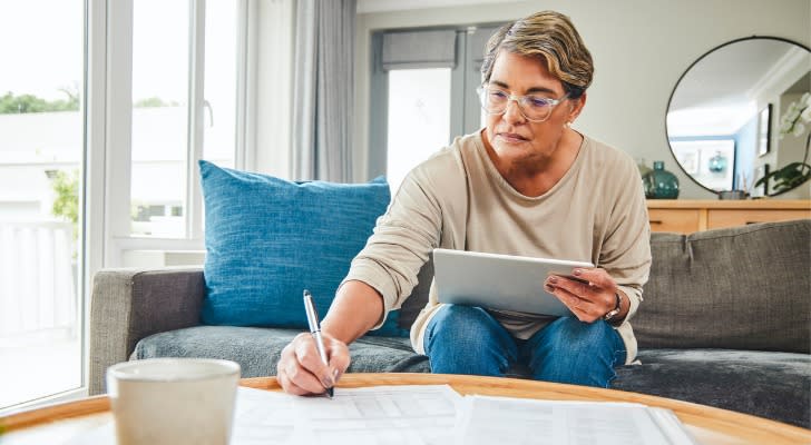 A woman reviews her IRA and company retirement savings balances. 