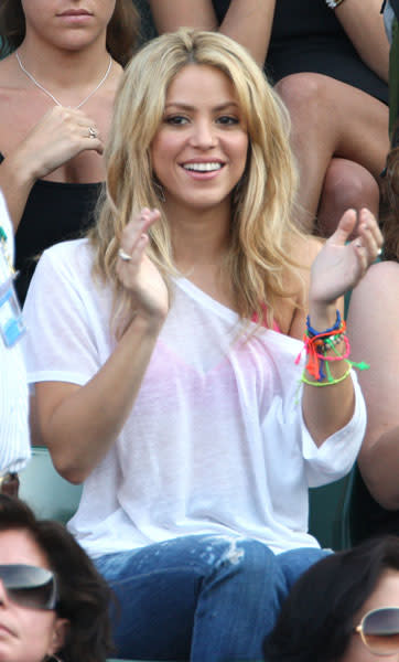 <b>Shakira at Wimbledon 2010 </b><br><br>The singer looks beautiful whenever, wherever she goes... Excuse the pun. She's gone for a more low-key look for Wimbledon, choosing surfer-chick waves, multi-coloured armbands, an off the shoulder white t-shirt and distressed jeans. Love the glimpse of the neon pink vest top, too.<br><br>© Rex