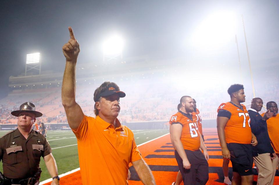 OSU coach Mike Gundy waves to the crowd after a 58-44 win against Central Michigan on Thursday in Stillwater. It was Gundy's 150th career win as head coach.