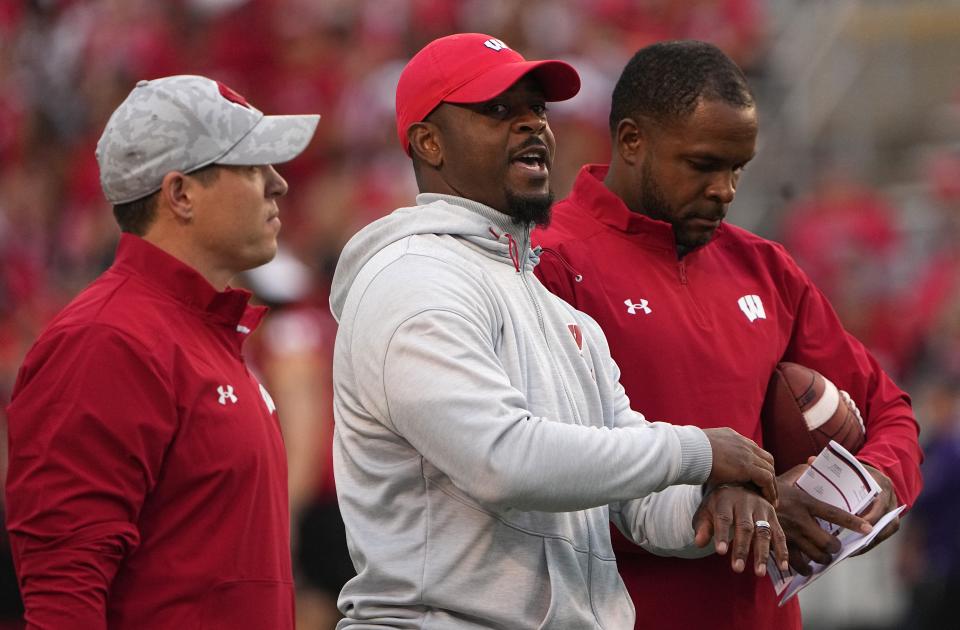 Ex-cornerbacks coach Hank Poteat, center, is at Iowa State.