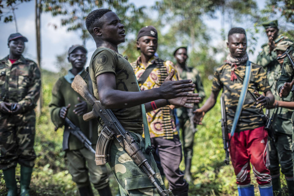 Armed militiamen gather near Rutshuru, 70 kms (45 miles) north of Goma, Democratic Republic of Congo,Wednesday June 22, 2022. Earlier in the week, East Africa's leaders have responded to the threat of war between Rwanda and Congo by instructing a new regional force to deploy in eastern Congo and ordering an immediate cease-fire. A statement after the meeting in Kenya's capital does not give details on the date of deployment of the force or its composition. (AP Photo/Moses Sawasawa)