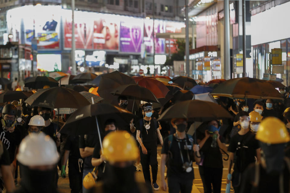 Protesters arrive at Causeway Bay to hold the anti-extradition bill protest, in Hong Kong, Sunday, Aug. 4, 2019. The first of two planned protests in Hong Kong on Sunday has kicked off from a public park just hours after police said they arrested more than 20 people for unlawful assembly and other offences during the previous night's demonstrations. (AP Photo/Vincent Thian)