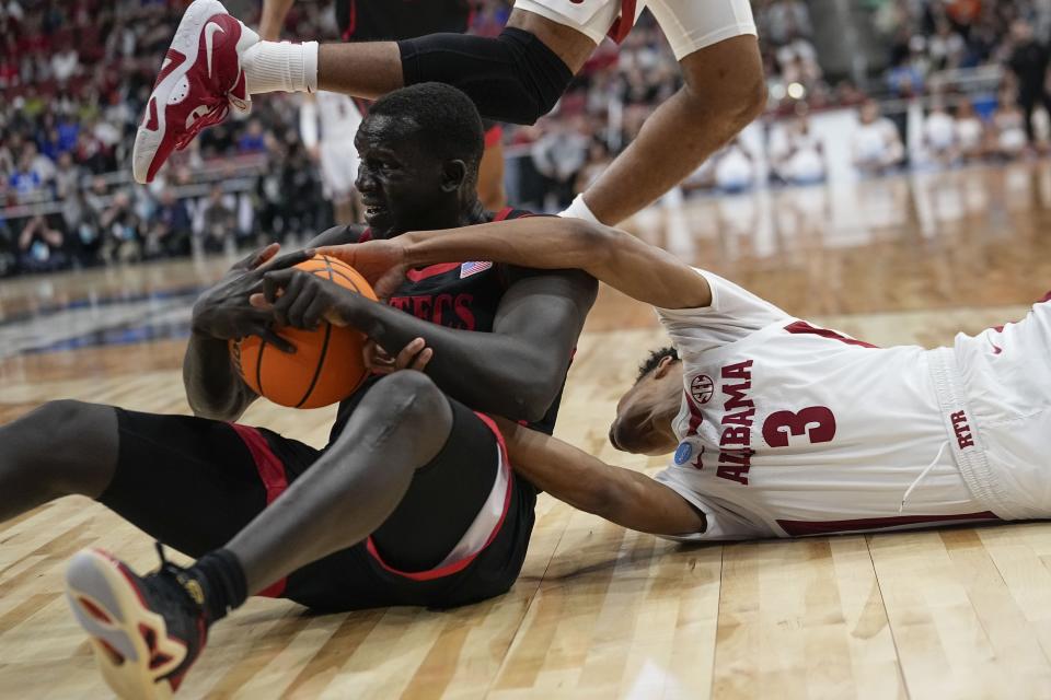 San Diego State forward Aguek Arop (33) and Alabama guard Rylan Griffen (3) battle for a loose ball in the first half of a Sweet 16 round college basketball game in the South Regional of the NCAA Tournament, Friday, March 24, 2023, in Louisville, Ky. (AP Photo/John Bazemore)