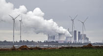 A coal fired power station steams near the Garzweiler surface coal mine in Germany, Friday, Sept. 25, 2020. Several groups like 'Friday for Future' or 'Ende Gelaende' started actions for climate justice in the coming days throughout Germany. The movement demands that the German government phase out coal by 2030 and make Germany carbon neutral by 2035. (AP Photo/Martin Meissner)