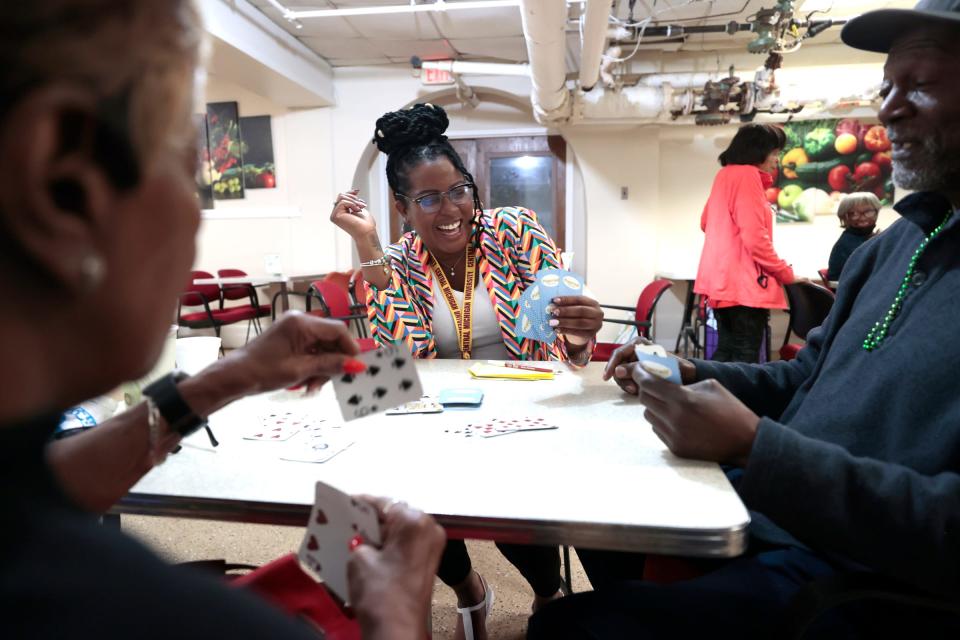 Dorothy Moses, 78, left, looks at her cards for her next move in the game of Tonk she was playing with Tina Skinner of the St. Patrick Senior Center in Detroit and her friend Jeff Miller, 66, of Detroit, on Wednesday, May 10, 2023. Skinner spends much of her day at the center going up and down three floors checking in on seniors, helping out, giving advice and giving them someone to talk to about their problems or issues they are dealing with.