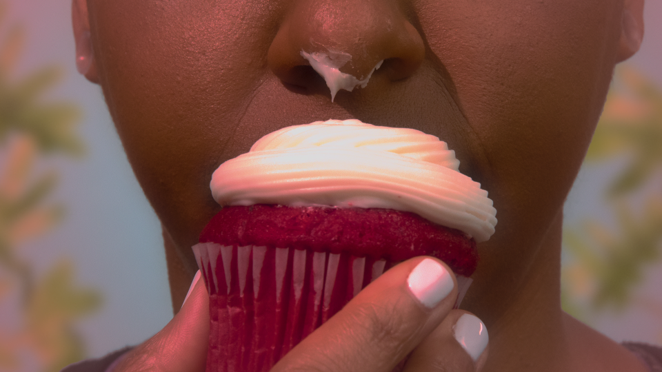 Woman eating a cupcake in Netflix's The Principles of Pleasure.