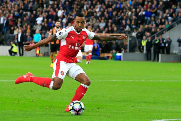 Arsenal's English midfielder Theo Walcott shoots and scores during the English Premier League football match between Hull City and Arsenal at the KCOM Stadium