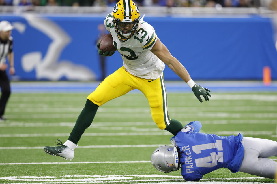 FILE - Green Bay Packers wide receiver Allen Lazard (13) is tackled by Detroit Lions cornerback AJ Parker (41) in the first half during an NFL football game Jan. 9, 2022, in Detroit. Lazard did not practice this week and is unlikely to play in their season opener Sunday, Sept. 11, 2022, at Minnesota. The team's injury report lists Lazard as doubtful due to an ankle injury. (AP Photo/Rick Osentoski, File)