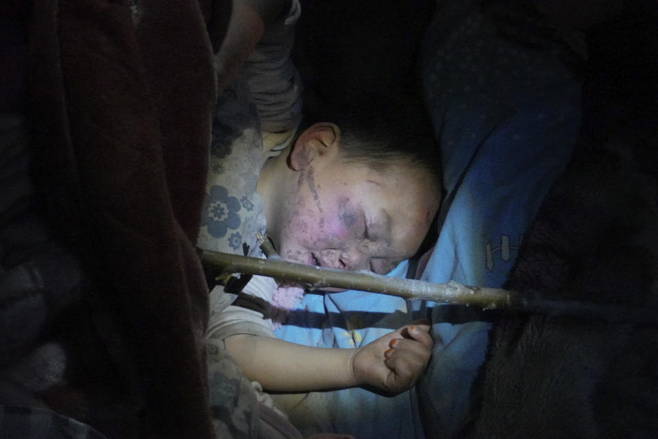 In this photo released by Xinhua News Agency, a child injured in an earthquake falls asleep after being treated and settled at a hospital in Jishishan Bao'an, Dongxiang, Salar Autonomous County in Linxia Hui Autonomous Prefecture, northwest China's Gansu Province, Dec. 19, 2023. An overnight earthquake killed multiple eople in a cold and mountainous region in northwestern China, the country's state media reported Tuesday. (Ma Xiping/Xinhua via AP)