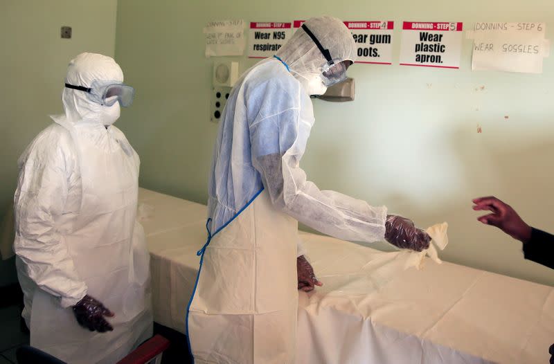 FILE PHOTO: Health workers in protective suits during a training exercise to prepare for any potential coronavirus cases at a hospital in Harare, Zimbabwe