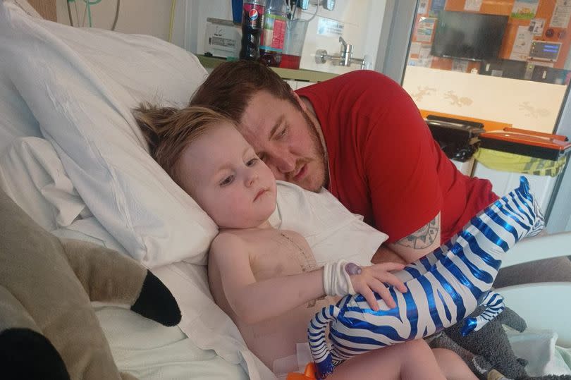 Enzo with his dad, Lee, in hospital