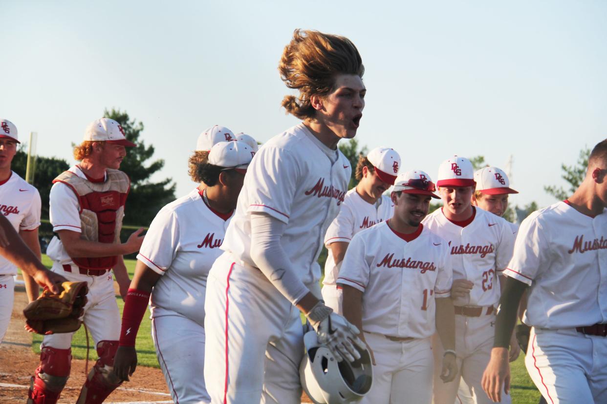 Dallas Center-Grimes' Taitn Gray cheers after scoring a home run during a substate game on Wednesday, July 17, 2024, in Dallas Center.