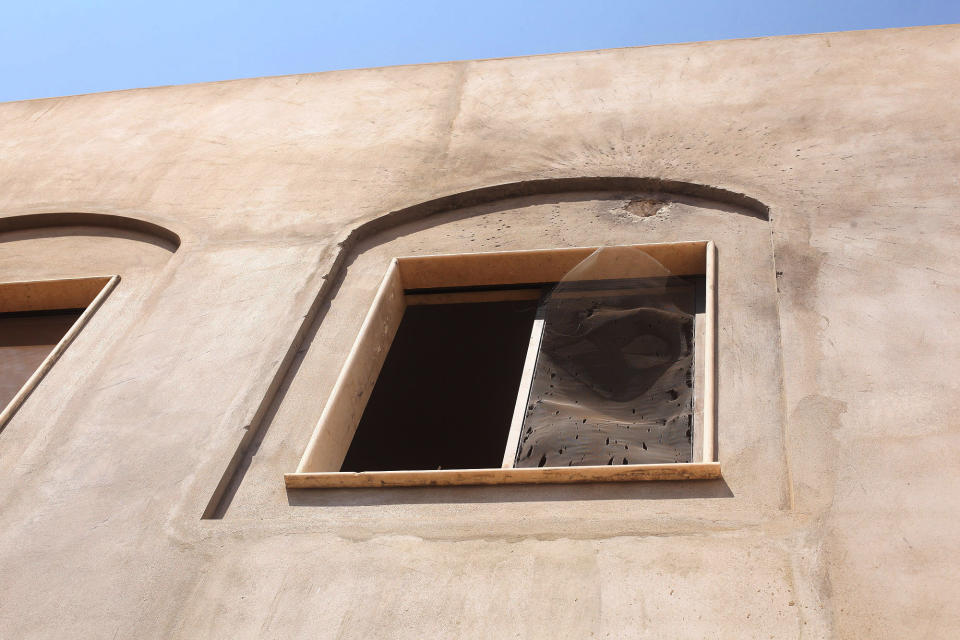 A broken window after an attack on the U.S. Consulate by protesters in Benghazi, Libya, Wednesday, Sept. 12, 2012. (AP Photo/Ibrahim Alaguri)