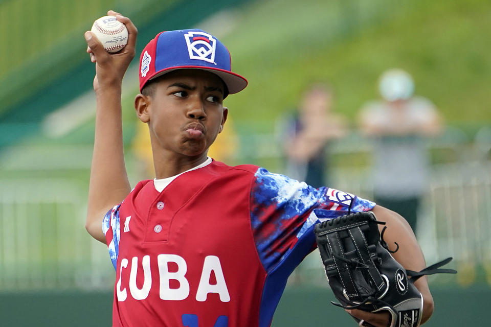 Cuba starting pitcher Luis Gurriel (14) throws to a Japan batter during the first inning of a baseball game at the Little League World Series tournament in South Williamsport, Pa., Wednesday, Aug. 16, 2023. Japan won 1-0. (AP Photo/Tom E. Puskar)