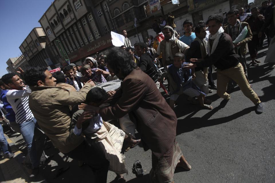 Supporters of the Houthi movement clash with anti-Houthi protesters during a rally in Sanaa