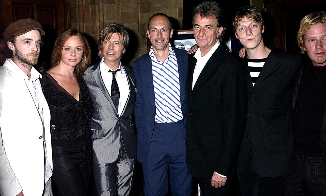 <span>Dylan Jones (centre) with the band Travis, Stella McCartney, David Bowie and designer Paul Smith at the GQ men of the year awards in 2002.</span><span>Photograph: Dave Benett/Getty Images</span>