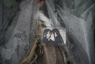 A keychain with a cartoon image is placed on top of flowers placed near the Kyoto Animation Studio building destroyed in an attack Friday, July 19, 2019, in Kyoto, Japan. A man screaming "You die!" burst into the animation studio in Kyoto, doused it with a flammable liquid and set it on fire Thursday, killing dozens of people in the attack that shocked the country and brought an outpouring of grief from anime fans. (AP Photo/Jae C. Hong)