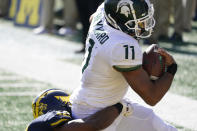 Michigan State running back Connor Heyward (11) is tackled in the end zone after a reception for a touchdown during the first half of an NCAA college football game against Michigan, Saturday, Oct. 31, 2020, in Ann Arbor, Mich. (AP Photo/Carlos Osorio)