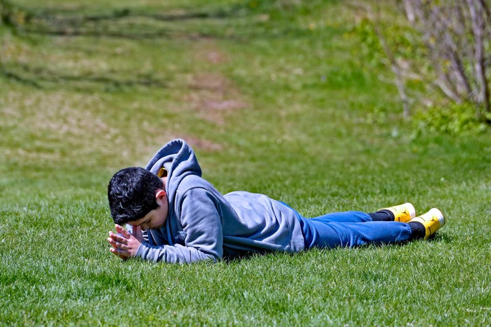 Notre Dame Middle School student, Emanuel Portugal takes a moment to pray at the Catholic Ecology Center in Neosho.