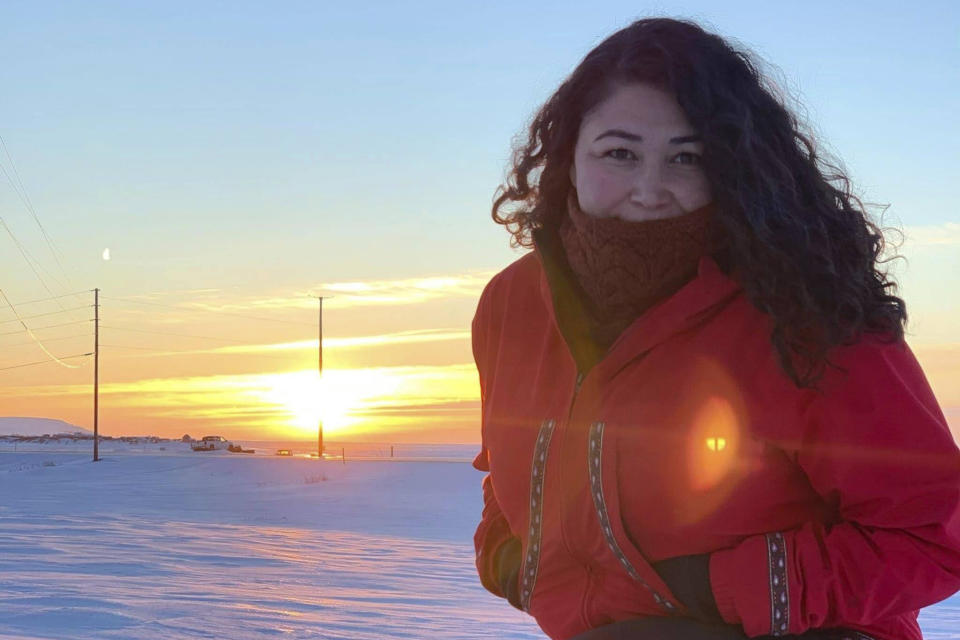 This undated photo shows Alice Bioff wearing an Atmik, a water-proof garment she makes that resembles the traditional Alaska Native garment called a kuspuk in Nome, Alaska. The garment was inspired by a tourist she met in 2016 when she was a tour guide, and she hopes the $600 million expansion of the Port of Nome will translate into support of Nome stores and Indigenous artists. (Alice Bioff via AP)