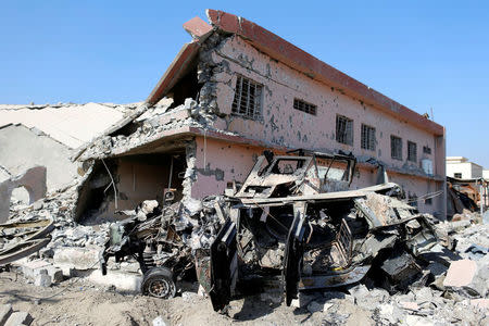 Damaged building and military vehicle are seen days after Iraqi forces clashed with Islamic State militants in Qaraqosh, near Mosul in Iraq October 30, 2016. REUTERS/Ahmed Jadallah