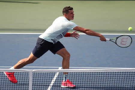 Aug 31, 2016; New York, NY, USA; Milos Raonic of Canada hits a volley against Ryan Harrison of the United States (not pictured) on day three of the 2016 U.S. Open tennis tournament at USTA Billie Jean King National Tennis Center. Harrison won 6-7(4), 7-5, 7-5, 6-1. Mandatory Credit: Geoff Burke-USA TODAY Sports