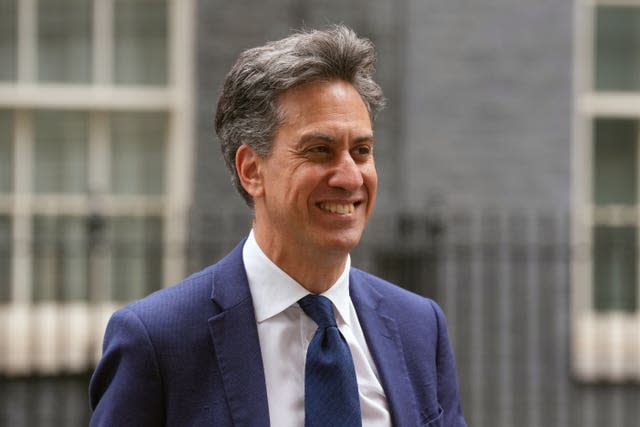 Ed Miliband, dressed in suit jacket, shirt and tie, smiling outside Number 10