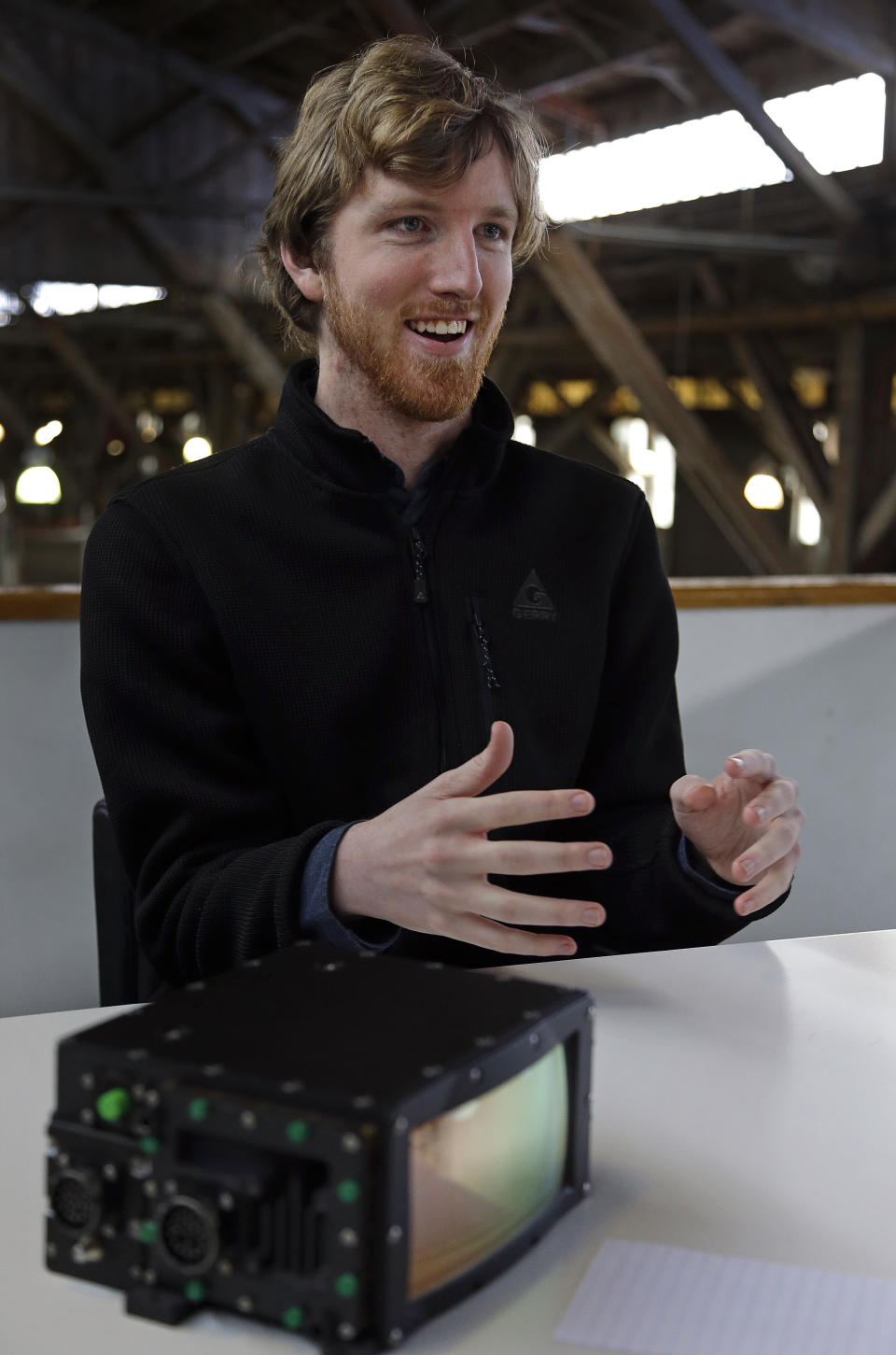 In this photograph taken on Monday, April 10, 2017, Luminar CEO Austin Russell gestures while speaking to a reporter in San Francisco. Russell, now 22, was barely old enough to drive when he set out to create a safer navigation system for robot-controlled cars. His ambitions are about to be tested five years after he co-founded Luminar Technologies, a Silicon Valley startup trying to steer the rapidly expanding self-driving car industry in a new direction. (AP Photo/Ben Margot)