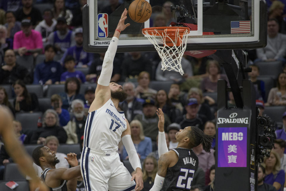 Memphis Grizzlies center Jonas Valanciunas (17) scores over Sacramento Kings forward Richaun Holmes (22) during the first quarter of an NBA basketball game in Sacramento, Calif., Thursday, Jan. 2, 2020. (AP Photo/Randall Benton)