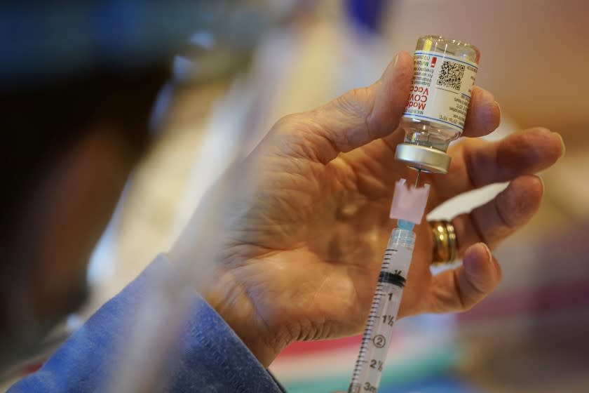 FILE - In this Dec. 29, 2020, file photo, Pat Moore, with the Chester County, Pa., Health Department, fills a syringe with Moderna COVID-19 vaccine before administering it to emergency medical workers and health care personnel at the Chester County Government Services Center in West Chester, Pa. Moderna says its COVID-19 vaccine strongly protects kids as young as 12. The company released the preliminary findings Tuesday, May 25, 2021, based on testing on more than 3,700 12- to 17-year-olds in the United States. (AP Photo/Matt Slocum, File)