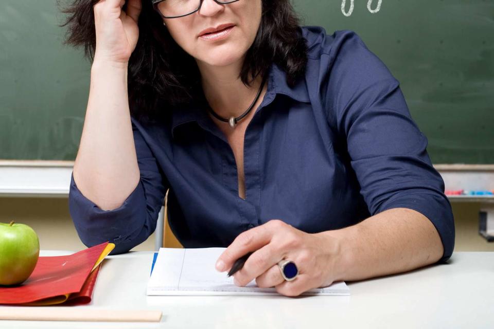 <p>Getty</p> Annoyed female Teacher in front of chalkboard.