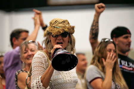 A supporter of Republican U.S. presidential nominee Donald Trump screams at members of the media working in a press area at a Trump campaign rally in West Palm Beach, Florida, U.S., October 13, 2016. REUTERS/Mike Segar