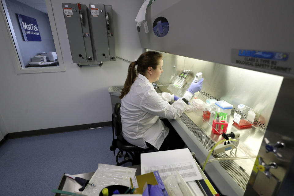 In this Wednesday, Jan. 15, 2020, photo, scientist and study director Jennifer Molignano uses an electronic pipette to prepare culture medium, a dark pink fluid that provides nutrition to living human skin tissue, as she sets up a demonstration of experiments at a MatTek Corporation lab, in Ashland, Mass. (AP Photo/Steven Senne)