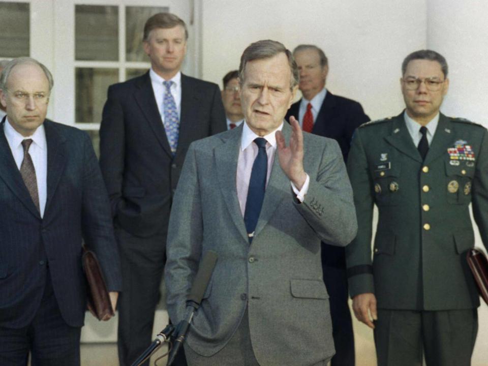 George HW Bush in the Rose Garden of the White House after meeting with top military advisors to discuss the Gulf War in 1991 (Ron Edmonds/AP)