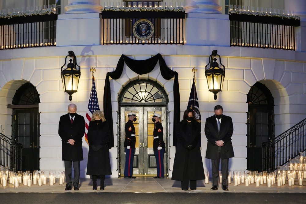 From left, President Joe Biden, First Lady Jill Biden, Vice President Kamala Harris and her husband Doug Emhoff, bow their heads during a ceremony to honor the 500,000 Americans that died from COVID-19, at the White House, Monday, Feb. 22, 2021, in Washington. (AP Photo/Evan Vucci)