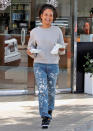 <p>A smiling Christina Milian heads out of Beignet Box Cafe in Los Angeles on May 17.</p>