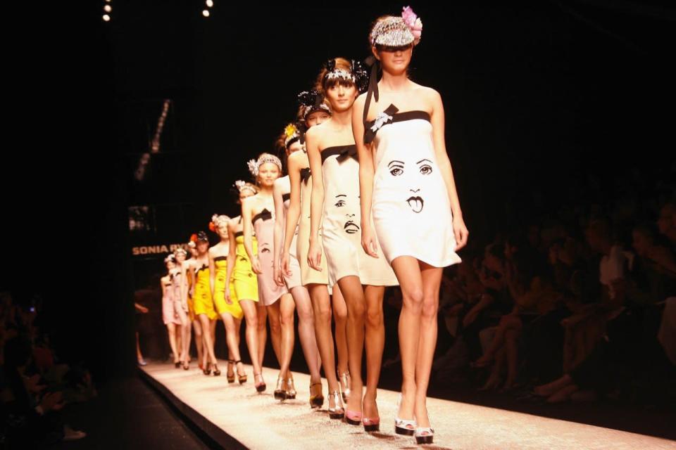 Models wear minidresses printed with faces at Sonia Rykiel’s spring 2007 show in Paris.