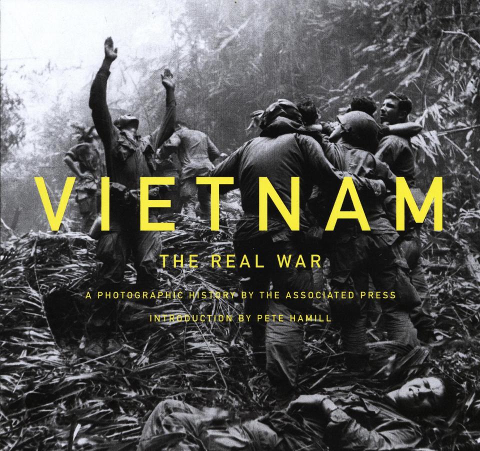 This book cover image released by Harry N. Abrams shows "Vietnam: The Real War: A Photographic History by the Associated Press." The holidays bring out the inner-coffee table book obsessive in gift buyers. They're easy, weighty and satisfying to give. (AP Photo/Harry N. Abrams)