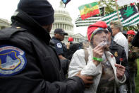 U.S. Capitol Hill police officers arrest protesters smoking marijuana on steps of the U.S. Capitol in Washington, U.S. April 24, 2017. REUTERS/Yuri Gripas