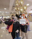 A passenger from New Zealand, second left, poses with drag queens as they welcome her at Sydney Airport in Sydney, Australia, Monday, April 19, 2021, as the much-anticipated travel bubble between Australia and New Zealand opens. (AP Photo/Rick Rycroft)